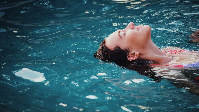 Adult learning to float in the water