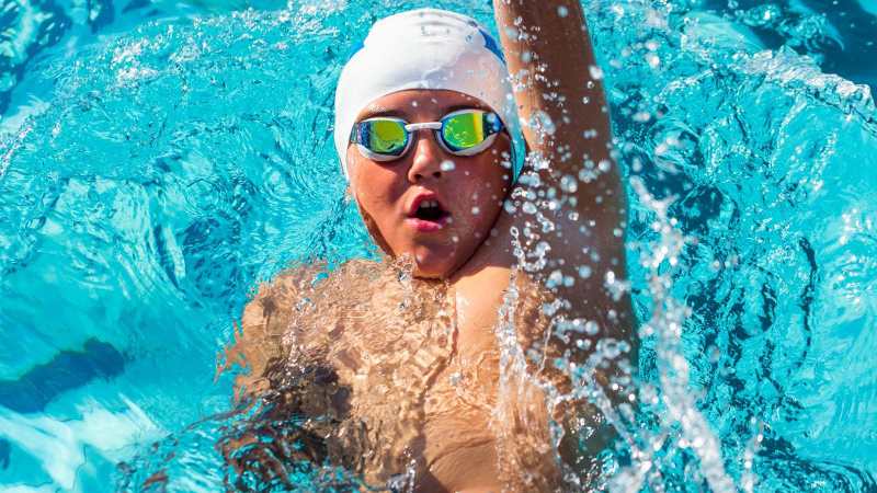 Child swimming backstroke