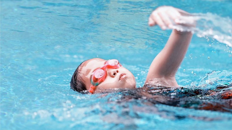 Child swimming freestyle